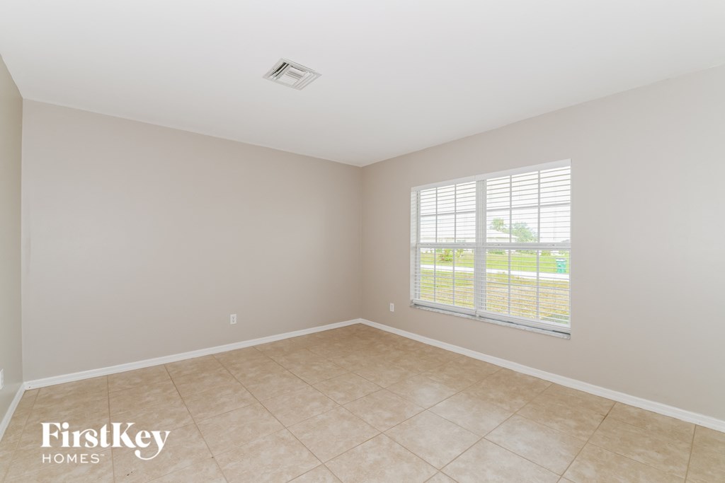 A room with a window and a tiled floor.