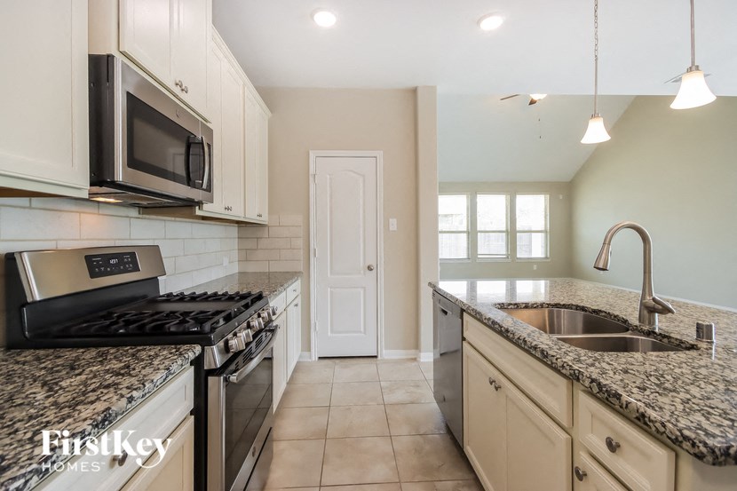 a kitchen with granite counter tops and stainless steel appliances