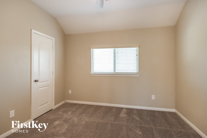 a room with carpet and a window and a door