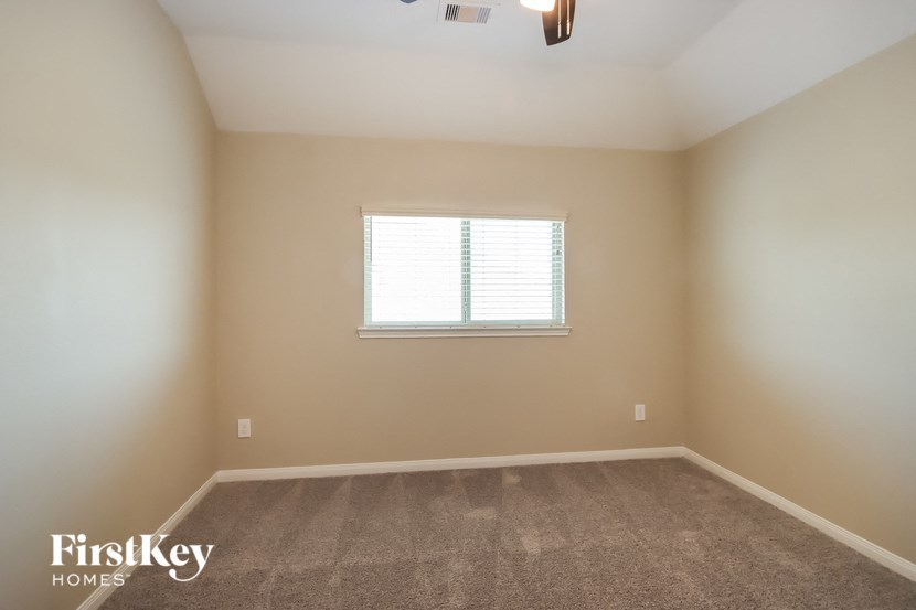 a empty room with a window and carpet