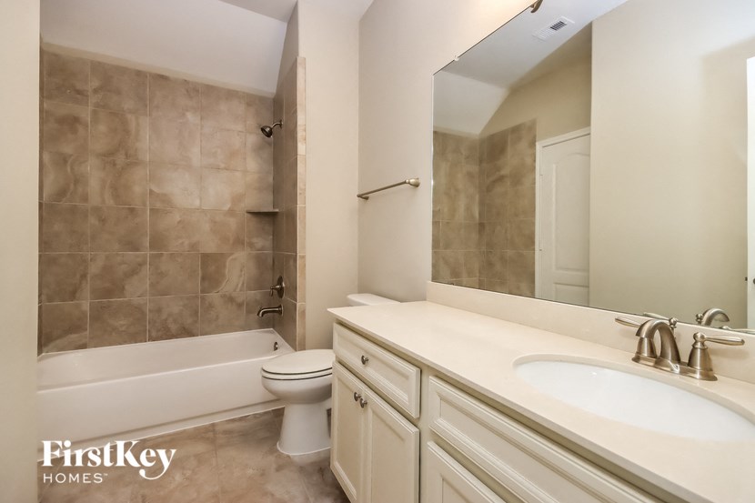 a bathroom with a sink toilet and a bath tub