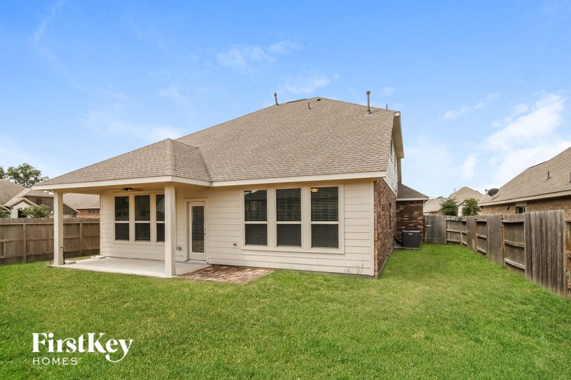 a small white house with a yard and a fence