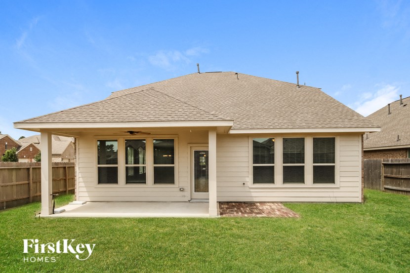 the front view of a white house with a porch and grass