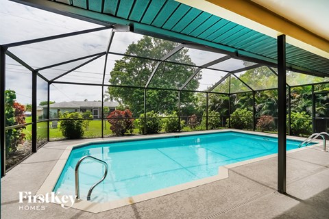 A pool under a green roof with Firstkey Homes written on the side.