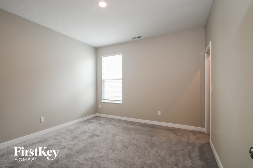 a room with a carpeted floor and a window