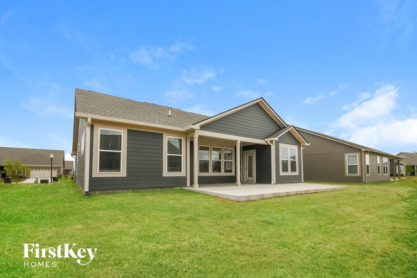 a home with a porch and a green lawn
