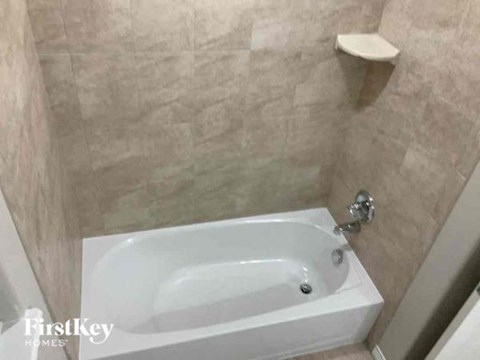a white bath tub in a bathroom next to a sink