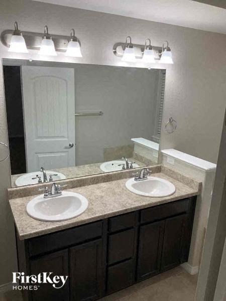a bathroom with two sinks and a mirror