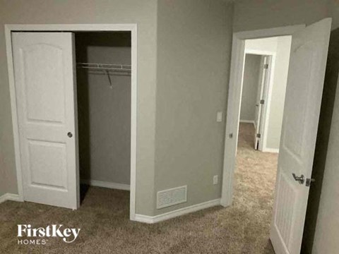 a bedroom with a closet and an open door