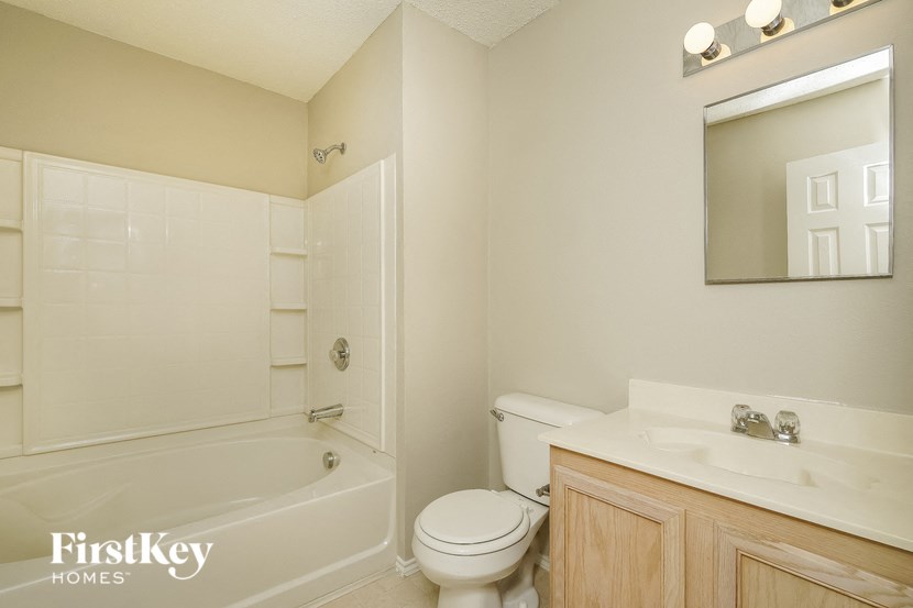 a bathroom with a toilet and a sink and a bath tub