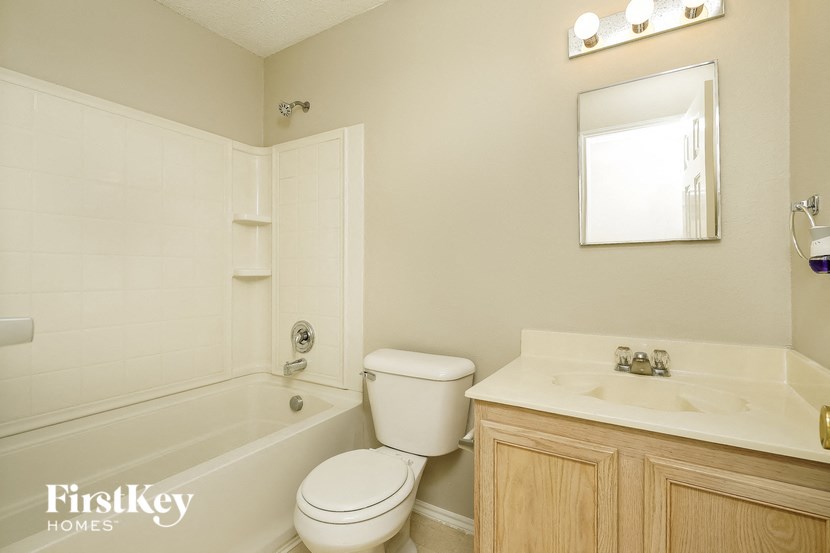 a white bathroom with a toilet sink and tub