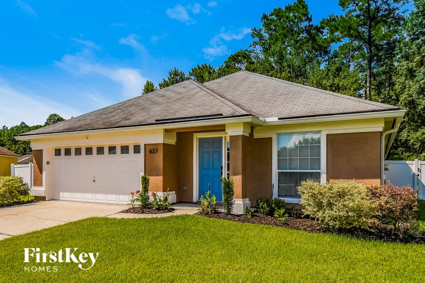 a house with a lawn and a blue door