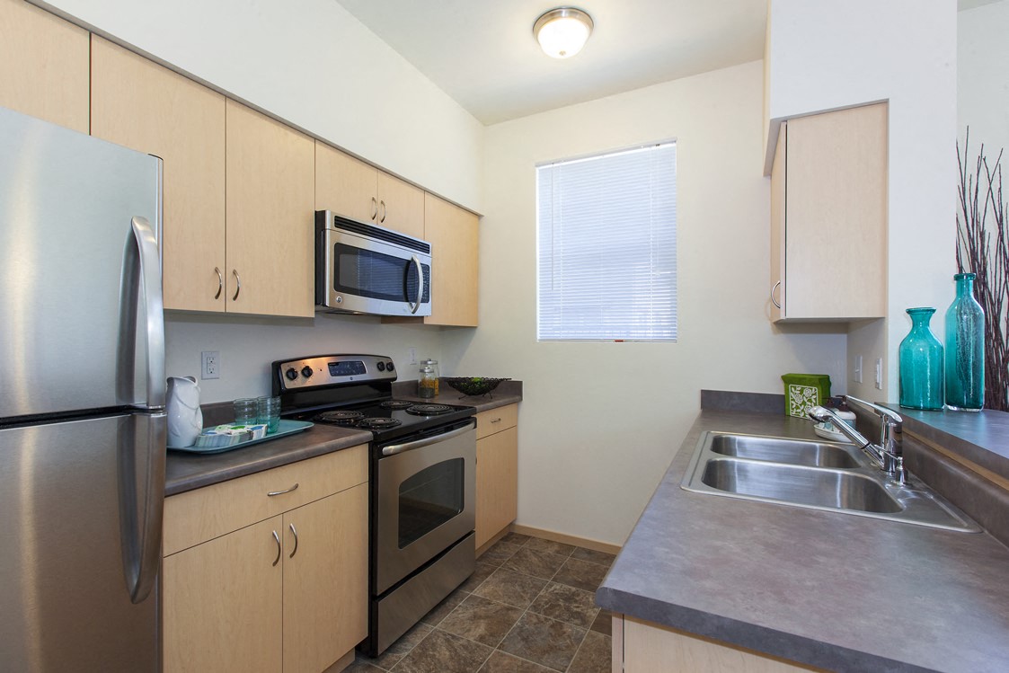 a kitchen with stainless steel appliances and a stainless steel sink
