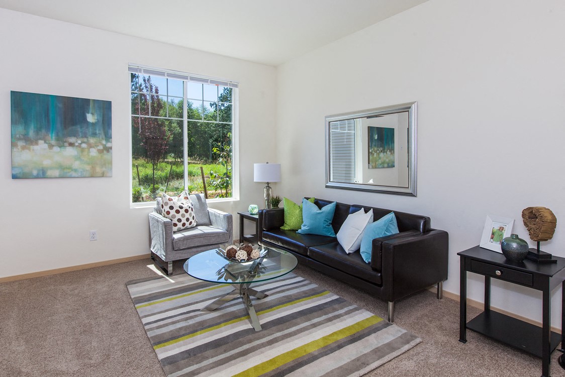 a living room with a couch and a table and a window