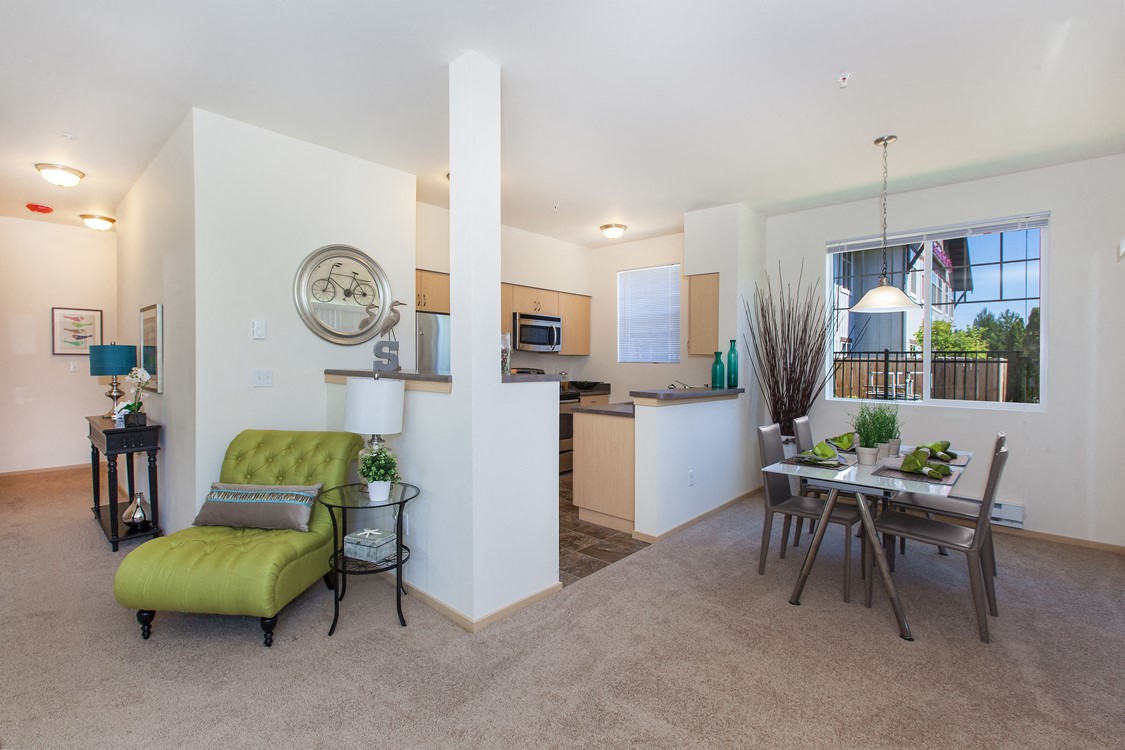 a living room with a dining room table and a kitchen
