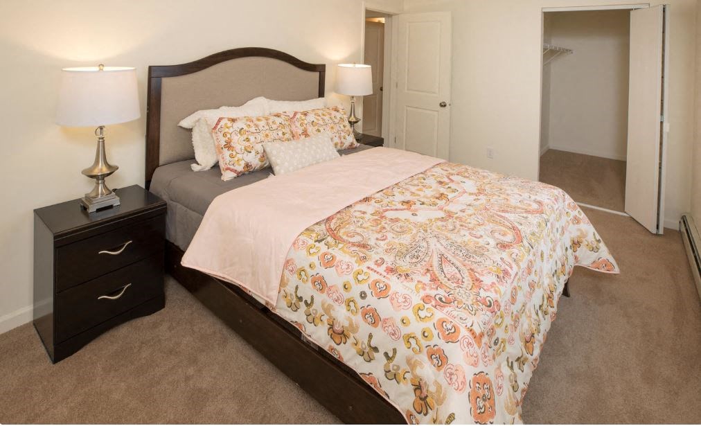 a bedroom with a bed and a night stand