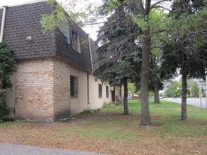 a brick house with trees in front of it