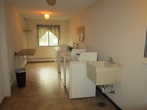 a bathroom with three sinks and a row of sinks