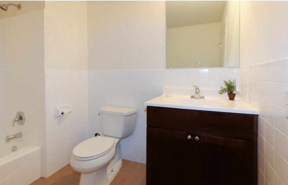 a bathroom with a toilet and a sink and a mirror