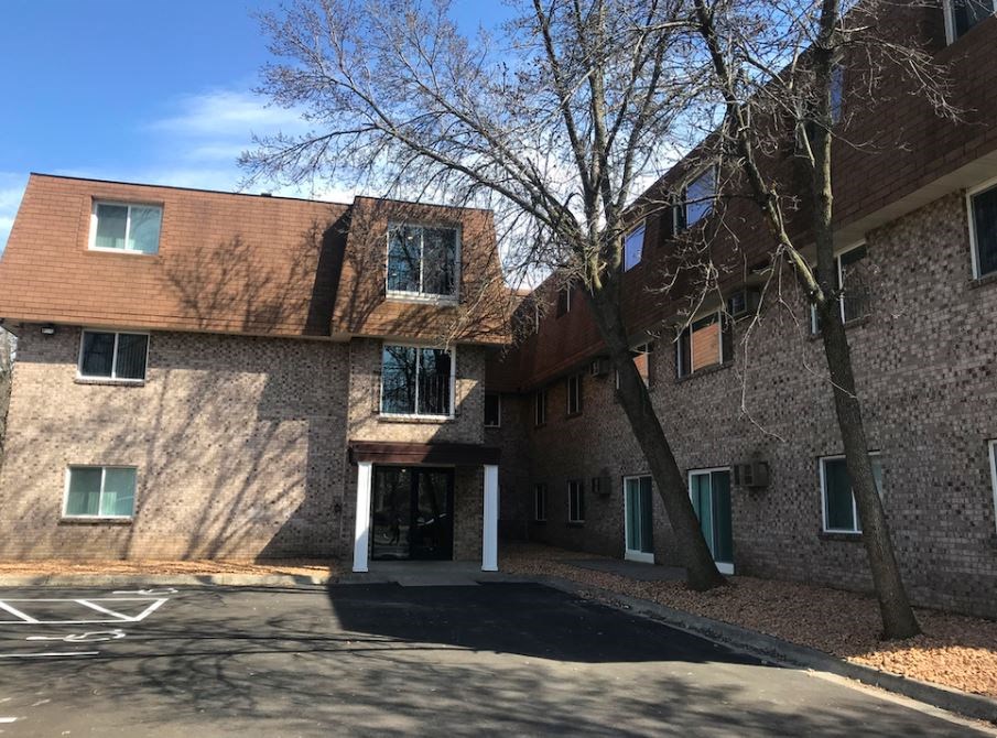 a large building with a tree in front of it