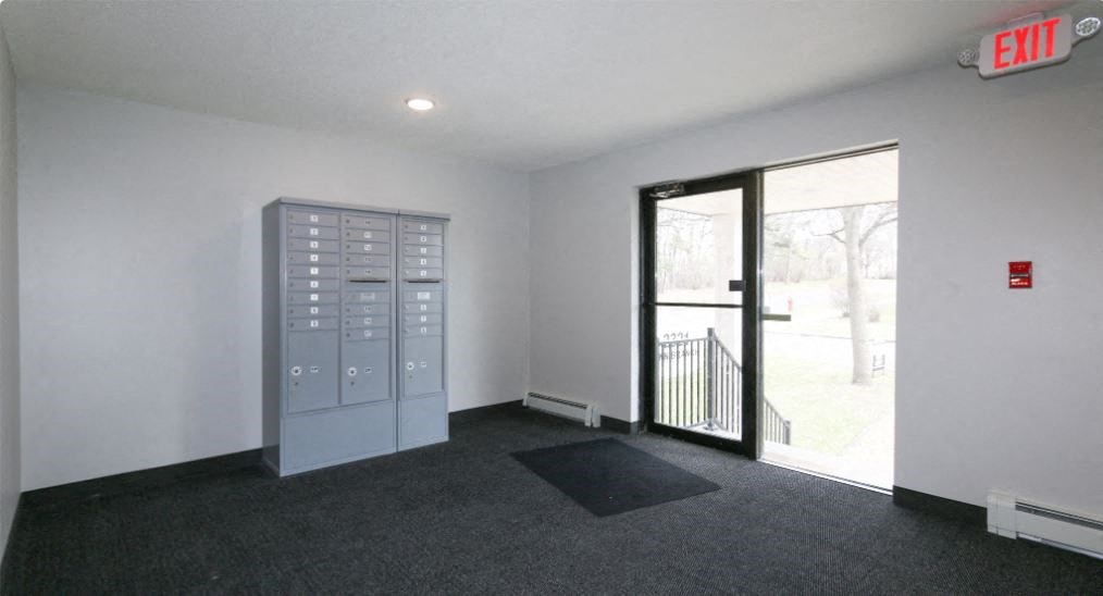 an empty room with a vending machine and a glass door