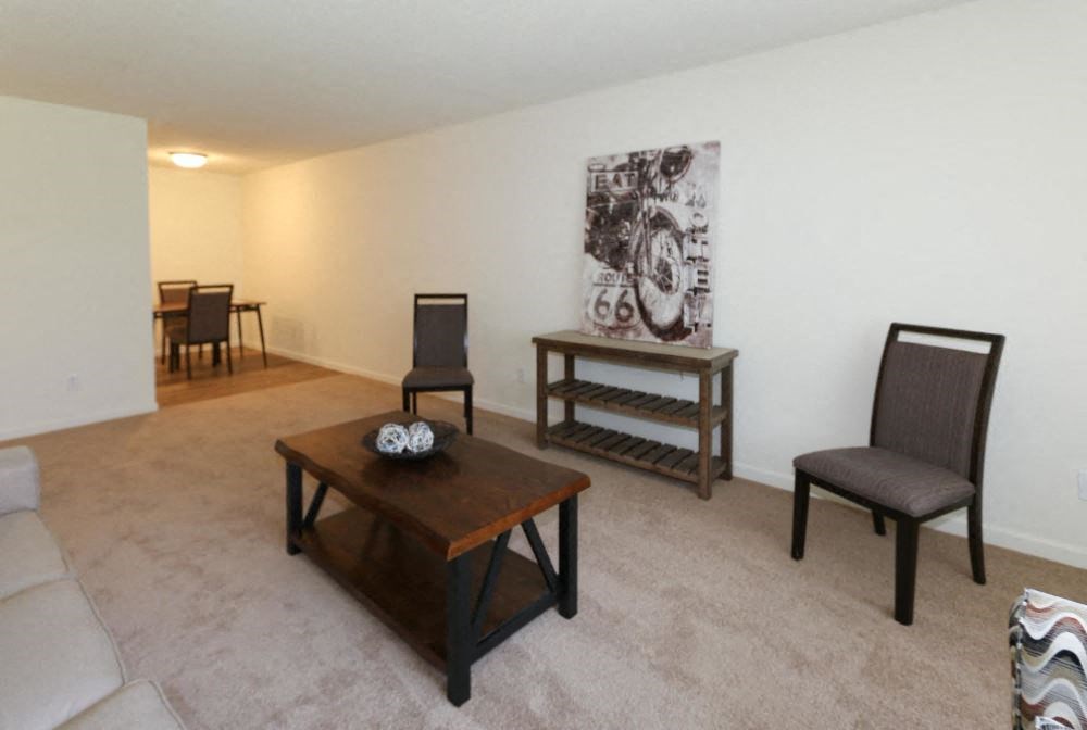 a living room with a couch and chairs and a table