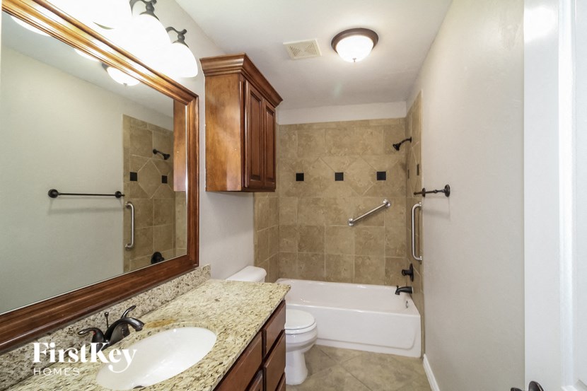 a bathroom with a sink and a toilet and a bath tub