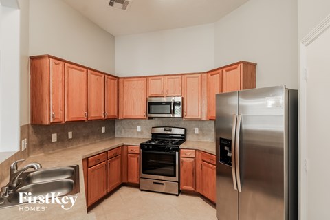 A kitchen with wooden cabinets and stainless steel appliances.