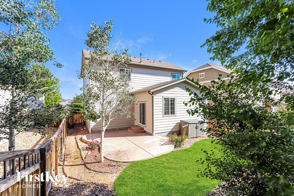 a white house with a yard and a fence
