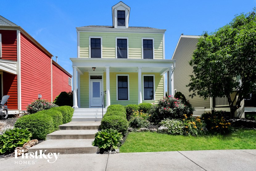 a white house with yellow trim and a roof
