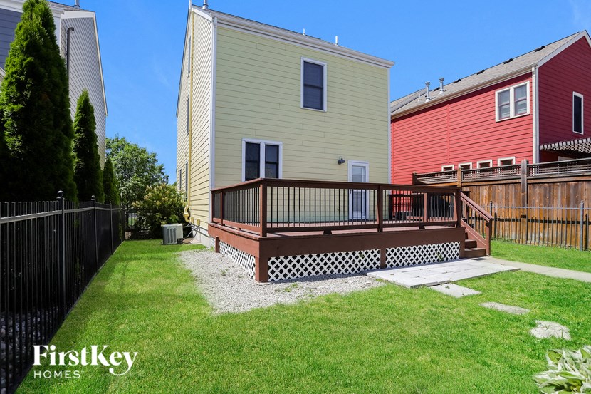 a backyard with a deck and a house