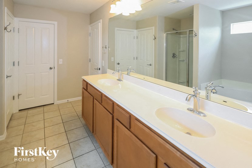 A bathroom with a double sink and a large mirror.