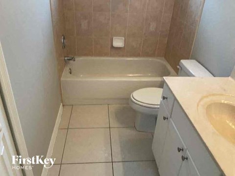 a bathroom with a toilet and a tub and a sink
