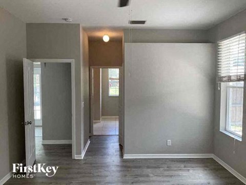 an empty living room with a hard wood floor