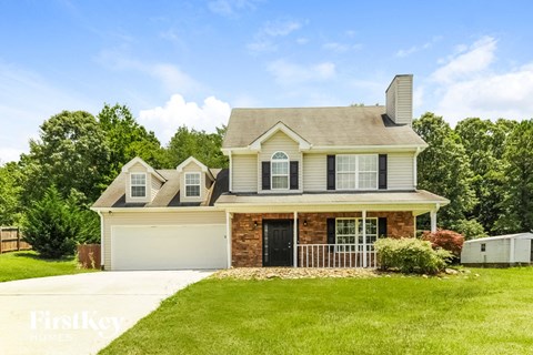 a house with a lawn and a driveway