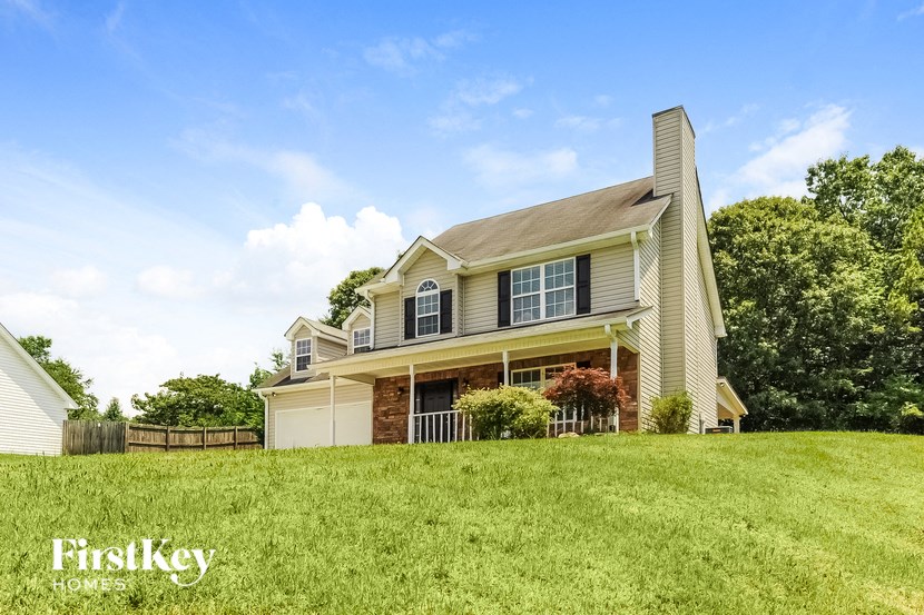 a house on top of a grass covered hill