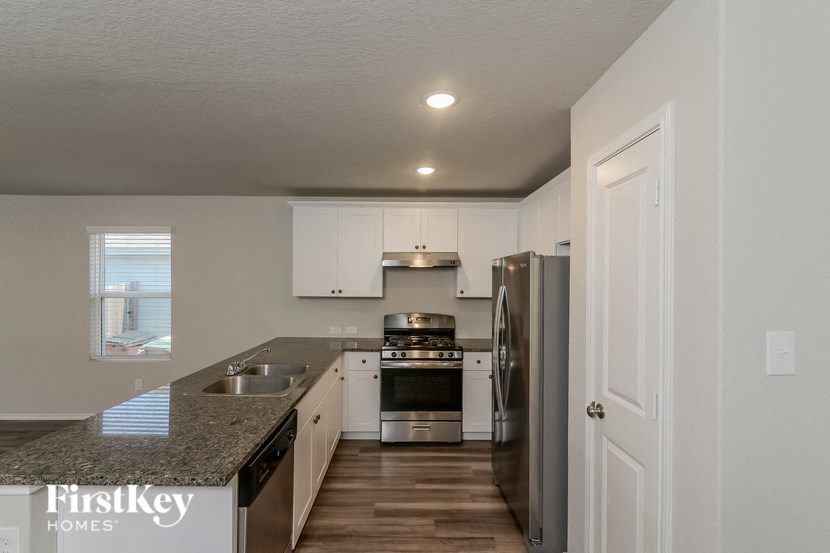 a kitchen with granite counter tops and stainless steel appliances