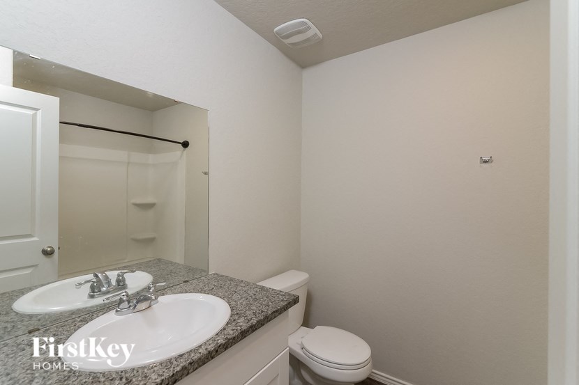 a bathroom with a sink and a toilet and a mirror