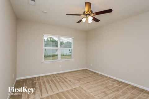 a living room with a ceiling fan and a window
