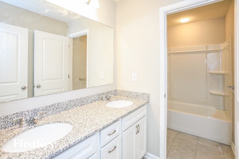 a bathroom with two sinks and a large mirror