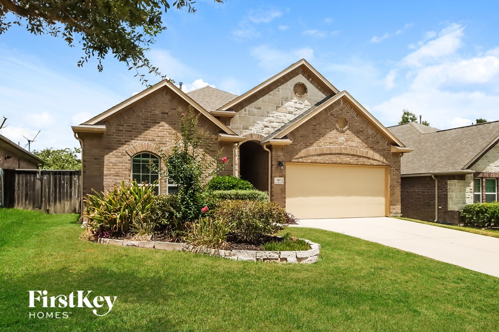 A house with a garage and a driveway is shown.