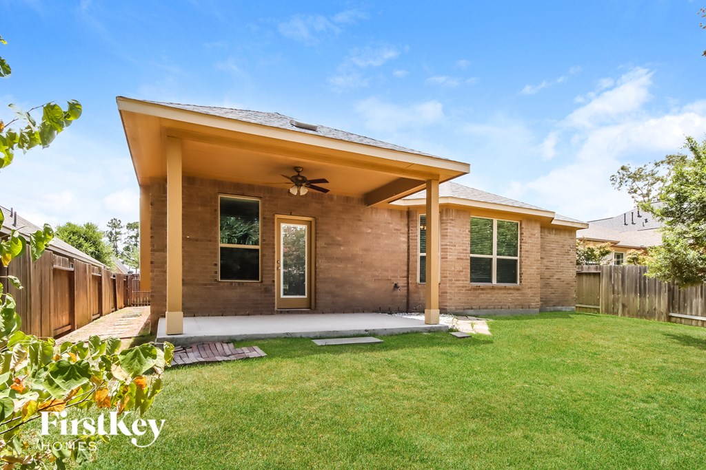 A house with a brown brick exterior and a covered patio area.