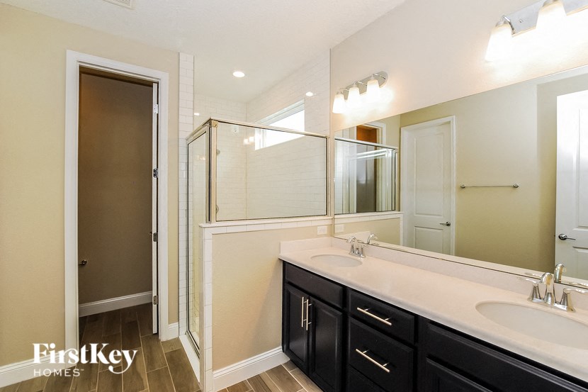A bathroom with a vanity and a large mirror.