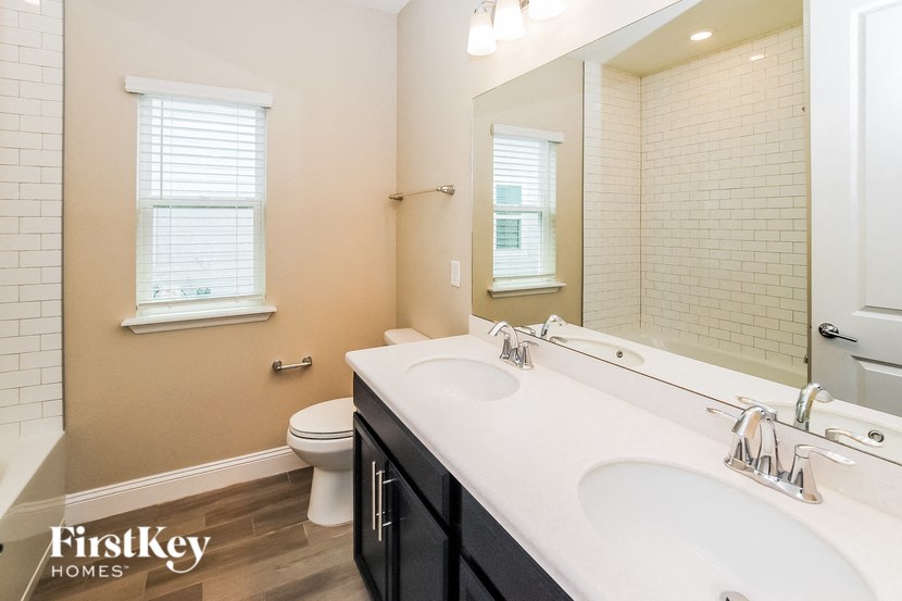 A bathroom with a white sink and a toilet.
