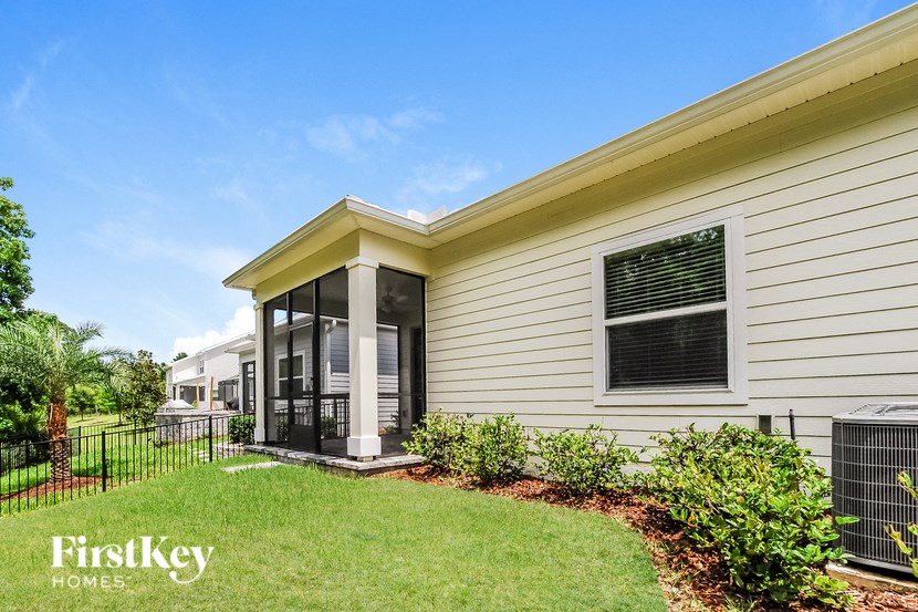 A house with a white siding and a black fence.