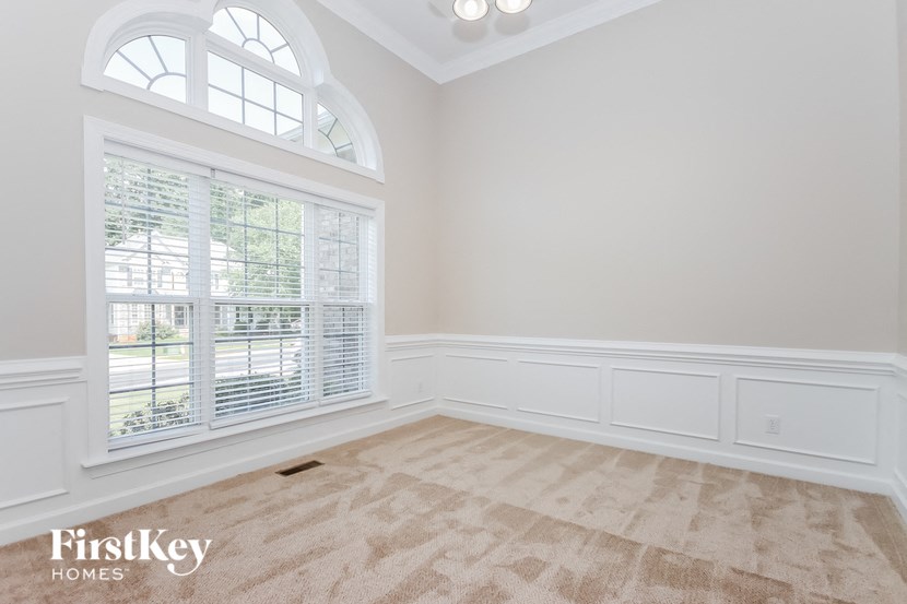 an empty living room with a large window