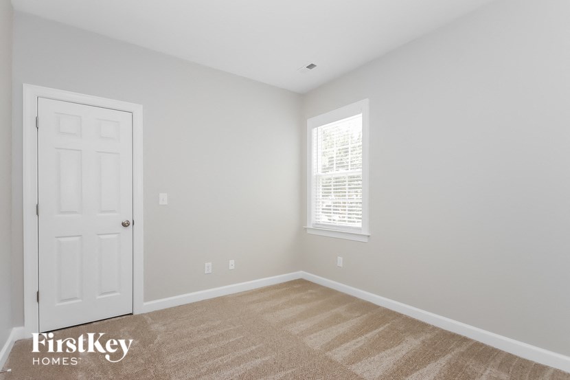 a empty room with a white door and a window