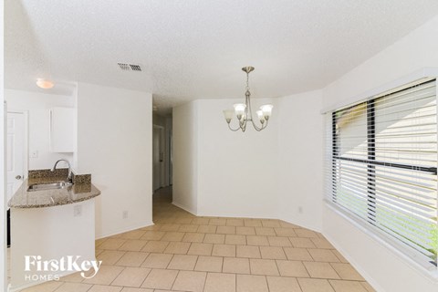 a kitchen and living room with a window and a sink