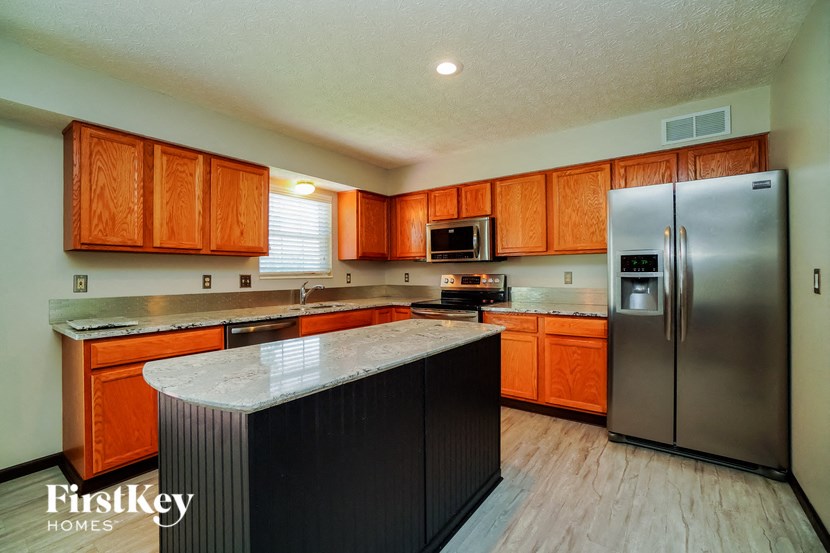 a kitchen with stainless steel appliances and wooden cabinets
