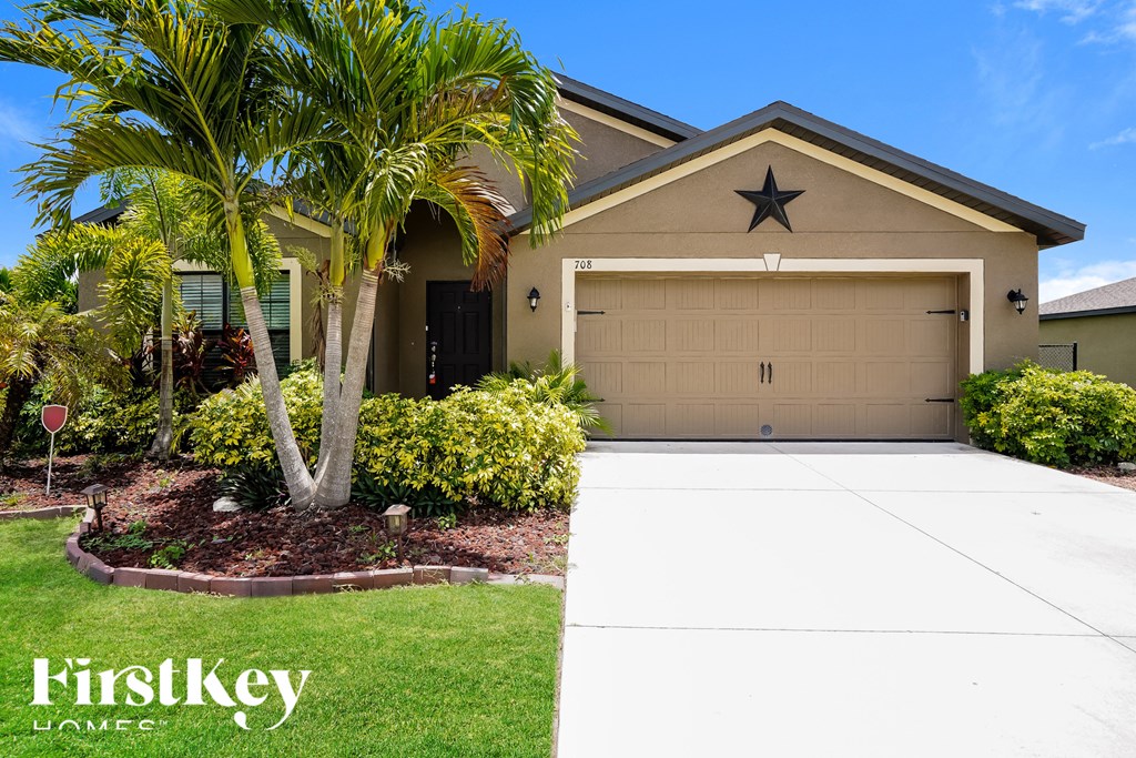 A house with a palm tree in front of it.